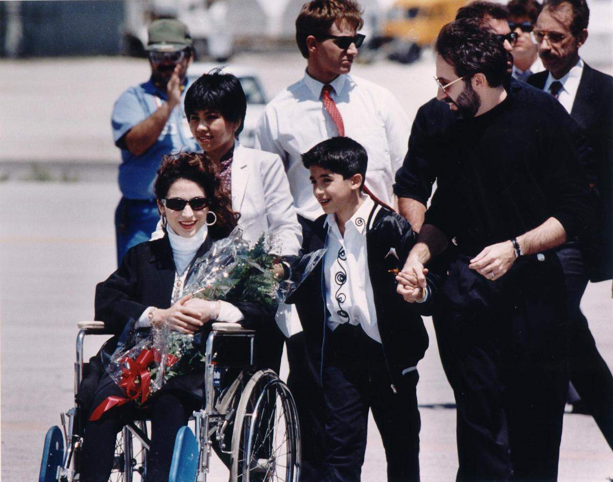 Singer Gloria Estefan returns to Miami International airport after a two-week hospital stay following a bus accident in Pennsylvania. About 200 fans and at least 50 members of the media welcomed Estefan, who said: “I’m so happy I got a sunshiny day. This is exactly what I need.”