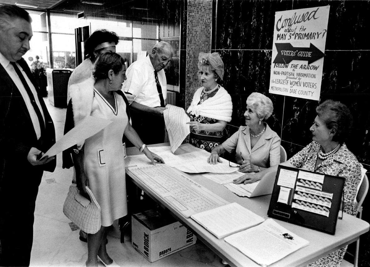 League of Women Voters members answer questions at a booth at a Lincoln Road bank building in South Beach in 1966.