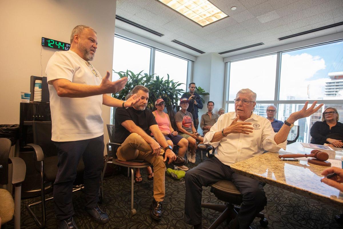 (L) David Restrepo, business owner and resident , talks to (R) Manolo Reyes Commissioner District 4 during a Sunshine Meeting on Saturday.