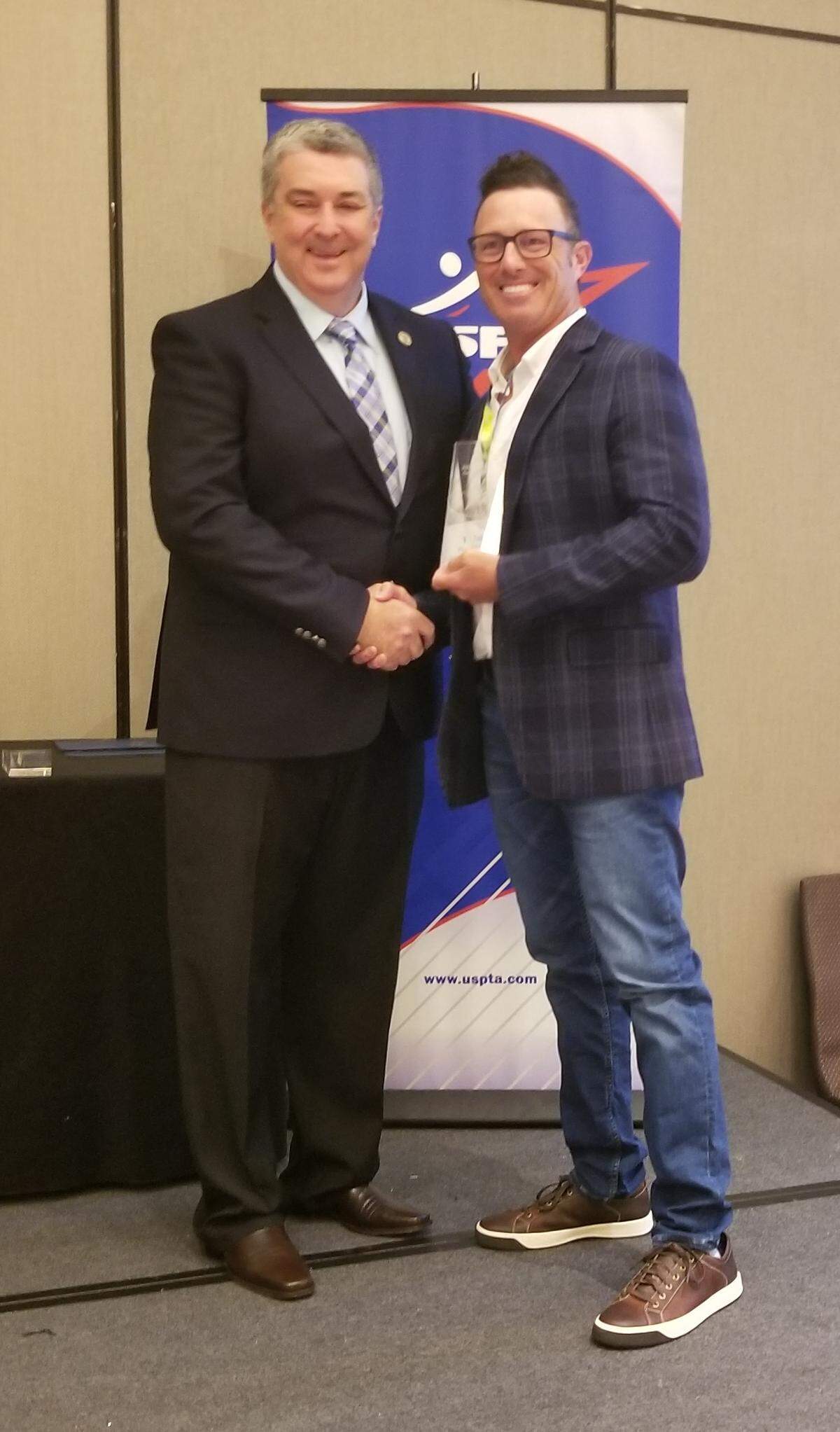 High School Coach of the Year Todd Rubinstein, right, with United States Professional Tennis Association President Gary Trost.