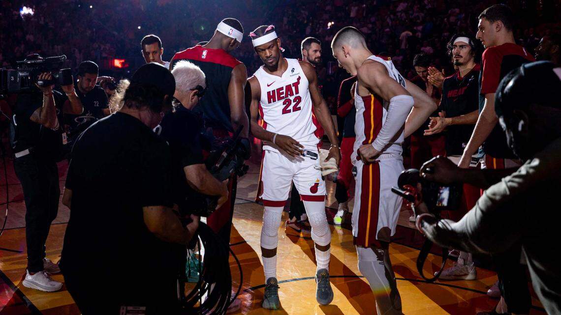 Miami Heat forward Jimmy Butler (22) interacts with teammate Bam Adebayo before the first half of an NBA game against the New Orleans Pelicans at Kaseya Center on January 1, 2025, in Miami.