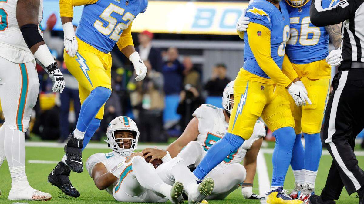 The Los Angeles Chargers linebacker Khalil Mack (52), linebacker Kyle Van Noy (8), and defensive end Morgan Fox (56) react after Miami Dolphins quarterback Tua Tagovailoa (1) is sacked in the second quarter at SoFi Stadium in Inglewood, California on Sunday, December 11, 2022.
