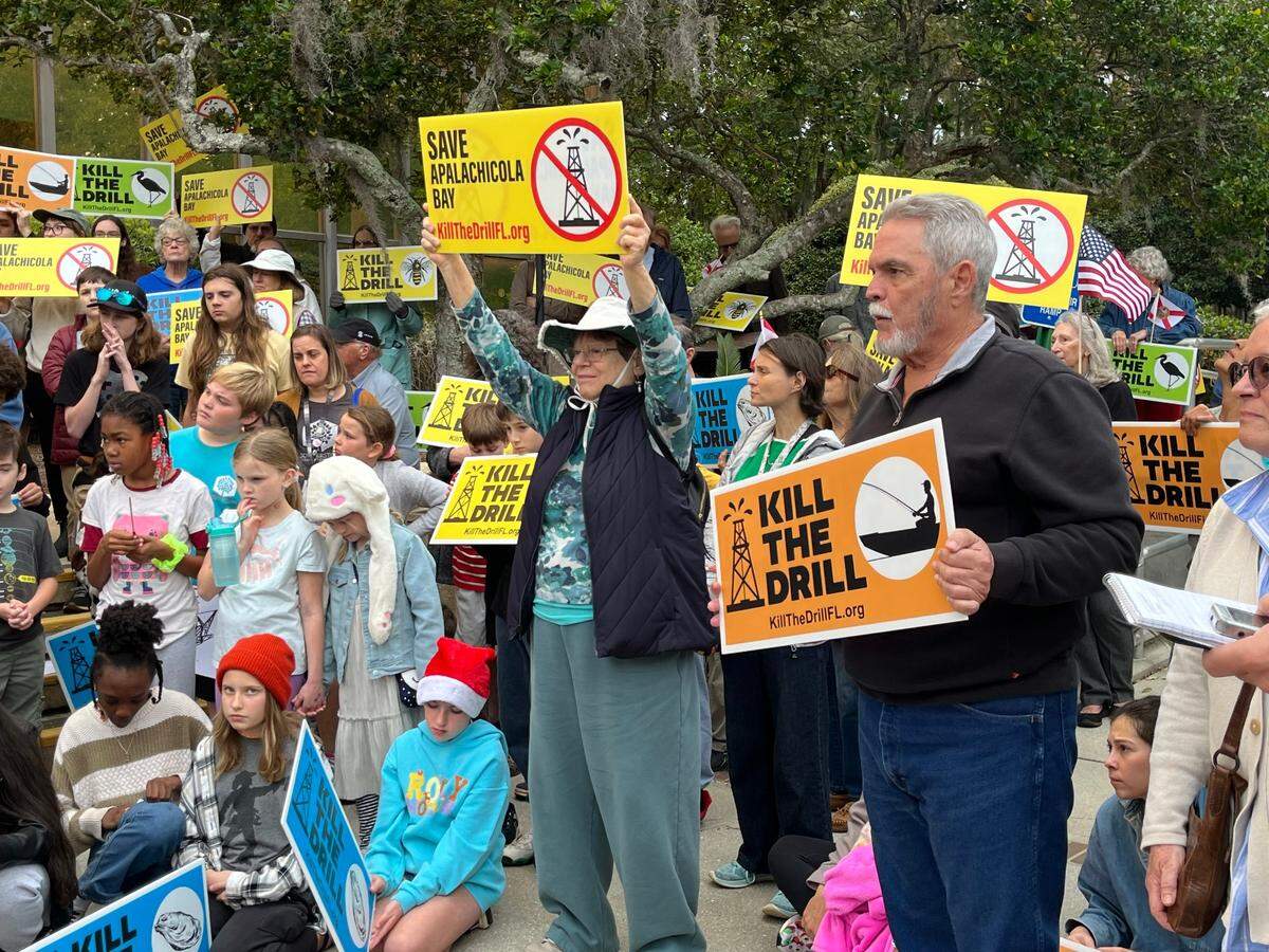 Leslie Wurster, center, a retired state worker from Tallahassee, was one of about 200 people who attended a protest outside the Florida Department of Environmental Protection’s headquarters in Tallahassee on Monday, Dec. 9, 2024.