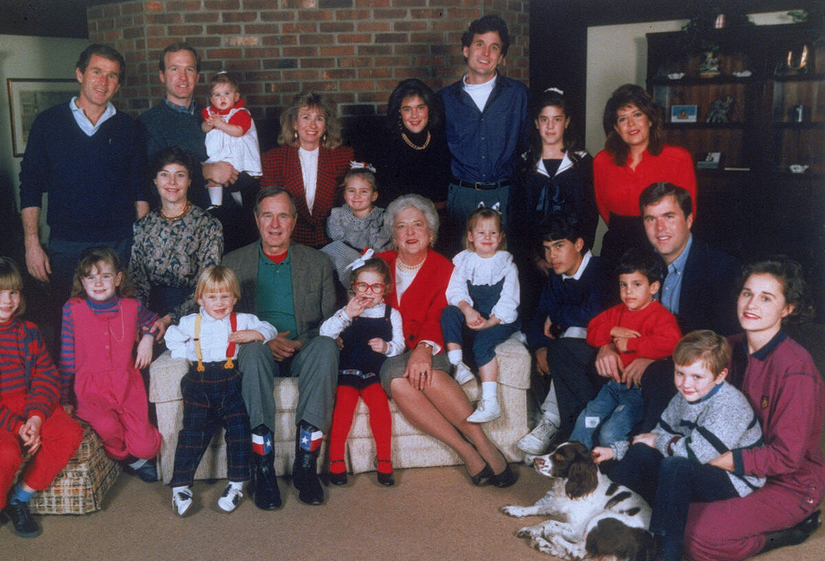 U.S. President George Bush and his wife Barbara, seated in the center, pose with their children and grandchildren at Camp David, Md., in 1989. (AP Photo)