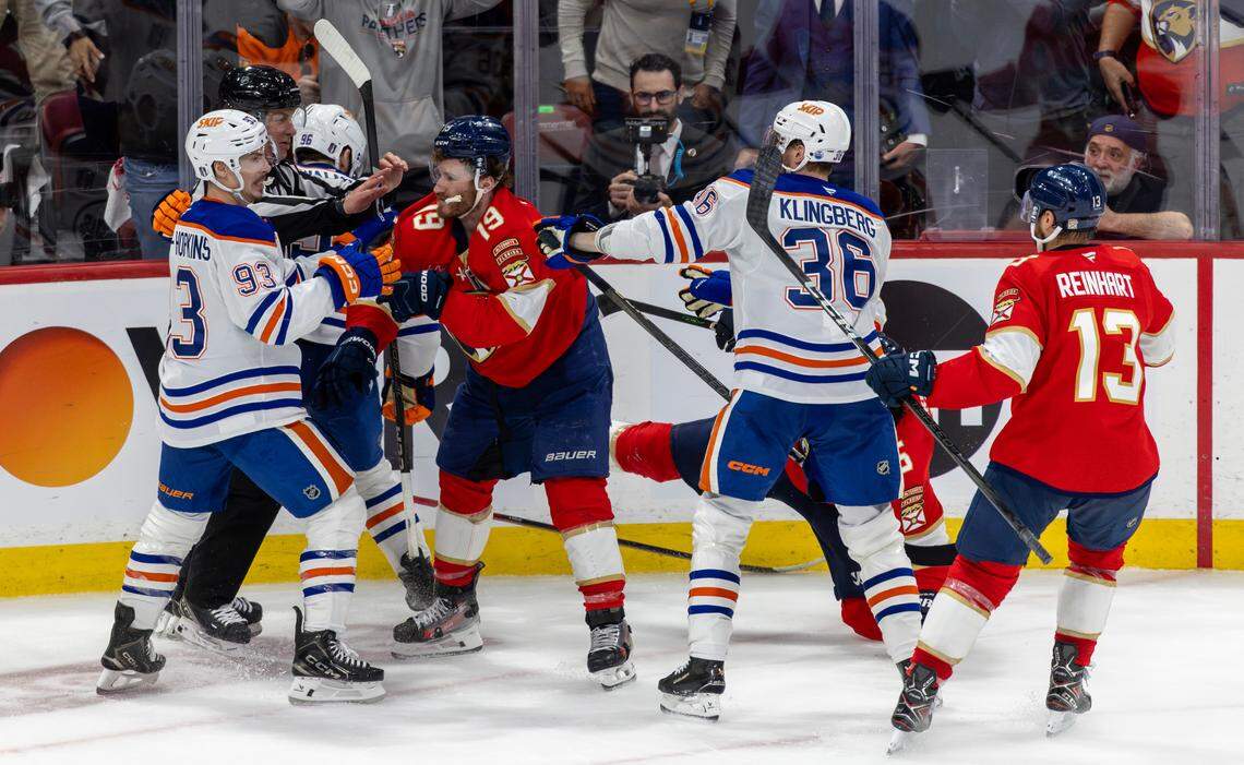 NHL linesman Scott Cherrey (50) attempts to break up multiple fights between Florida Panthers players Matthew Tkachuk (19), Aaron Ekblad (5), and Sam Reinhart (13) and Edmonton Oilers players Jake Walman (96), Ryan Nugent-Hopkins (93), and John Klingberg (36) during the third period of Game 3 in the Stanley Cup Final at Amerant Bank Arena on Monday, June 9, 2025, in Sunrise, Fla.