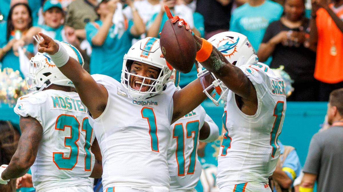Miami Dolphins wide receiver Trent Sherfield (14) celebrates with teammate Dolphins quarterback Tua Tagovailoa (1) after scoring a touchdown during second quarter of an NFL football game at Hard Rock Stadium on Sunday, November 13, 2022 in Miami Gardens, Florida.