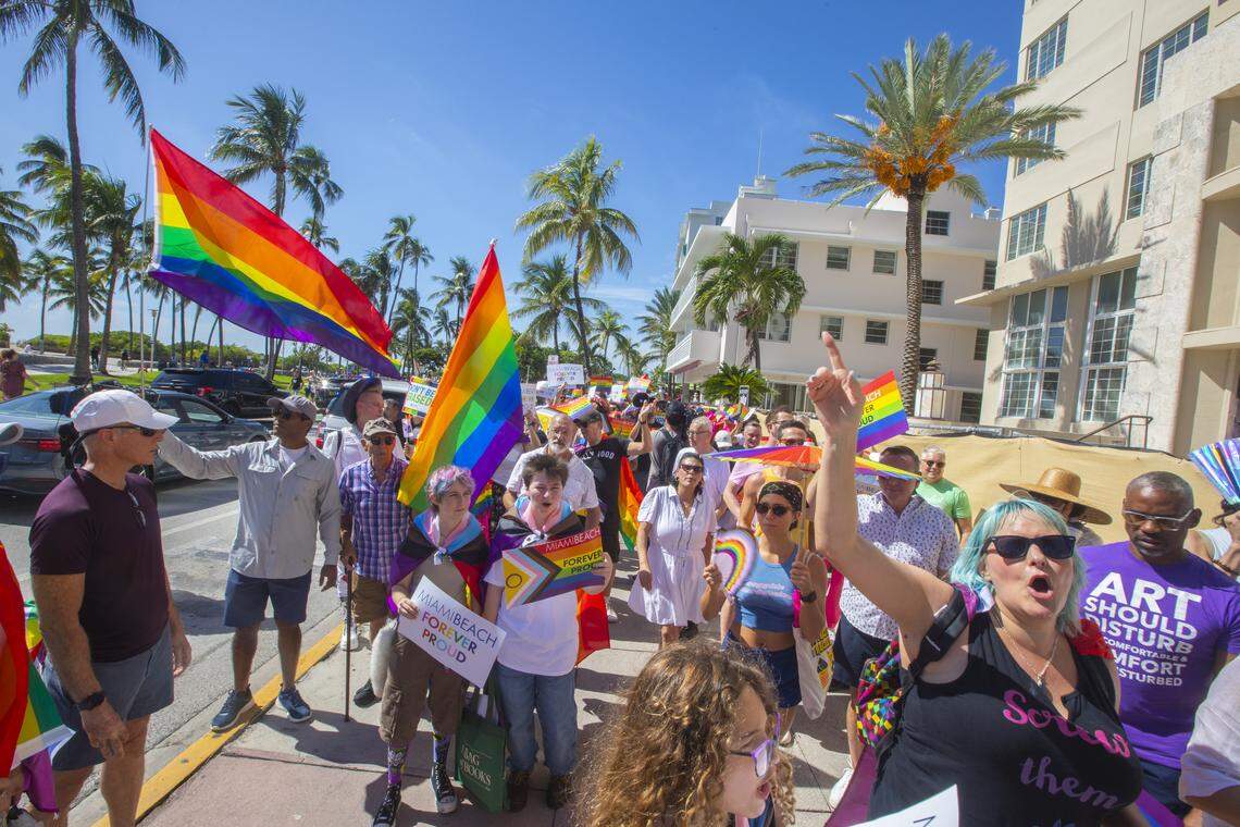 Demonstrators carrying rainbow flags and signs reading ‘Miami Beach Forever Proud’ and ‘Won’t Be Erased’ march during the Forever Proud March on Ocean Drive in Miami Beach, Fla., Sunday, Aug. 31, 2025, held after state officials ordered the removal of the city’s LGBTQ Pride crosswalk.