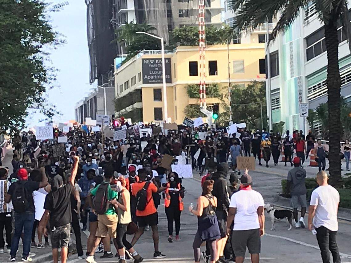 Marchers surge over a bridge between Huizenga Plaza and the Fort Lauderdale police station. There was a heavy police presence in the area, including Broward Sheriff’s Office deputies.