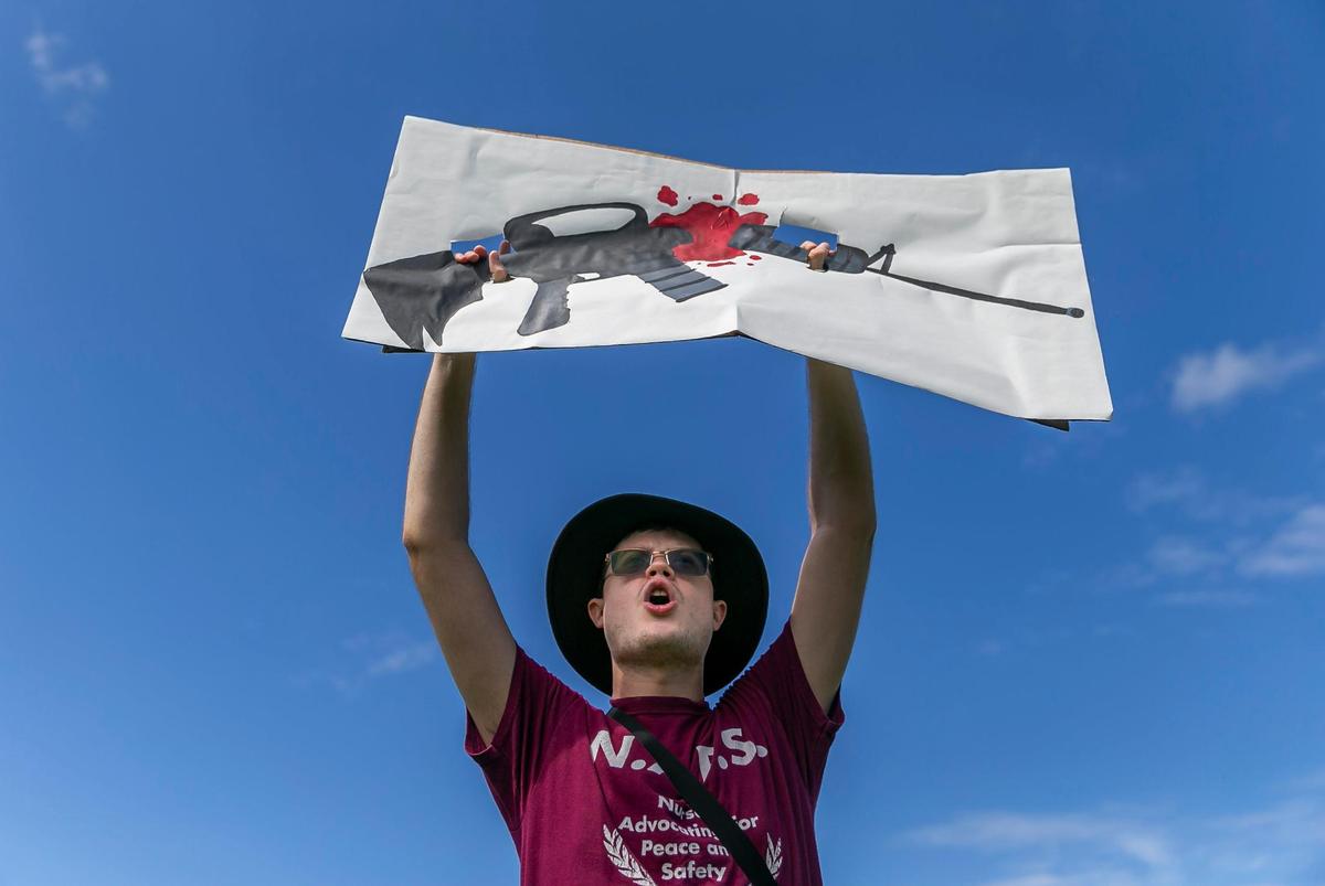 Ethan Vogt holds a sign during the March For Our Lives rally at Pine Trails Park on Saturday, June 11, 2022 in Parkland, Fla. One of the main goals of the rally is to increase pressure on politicians to pass laws that help prevent gun violence.