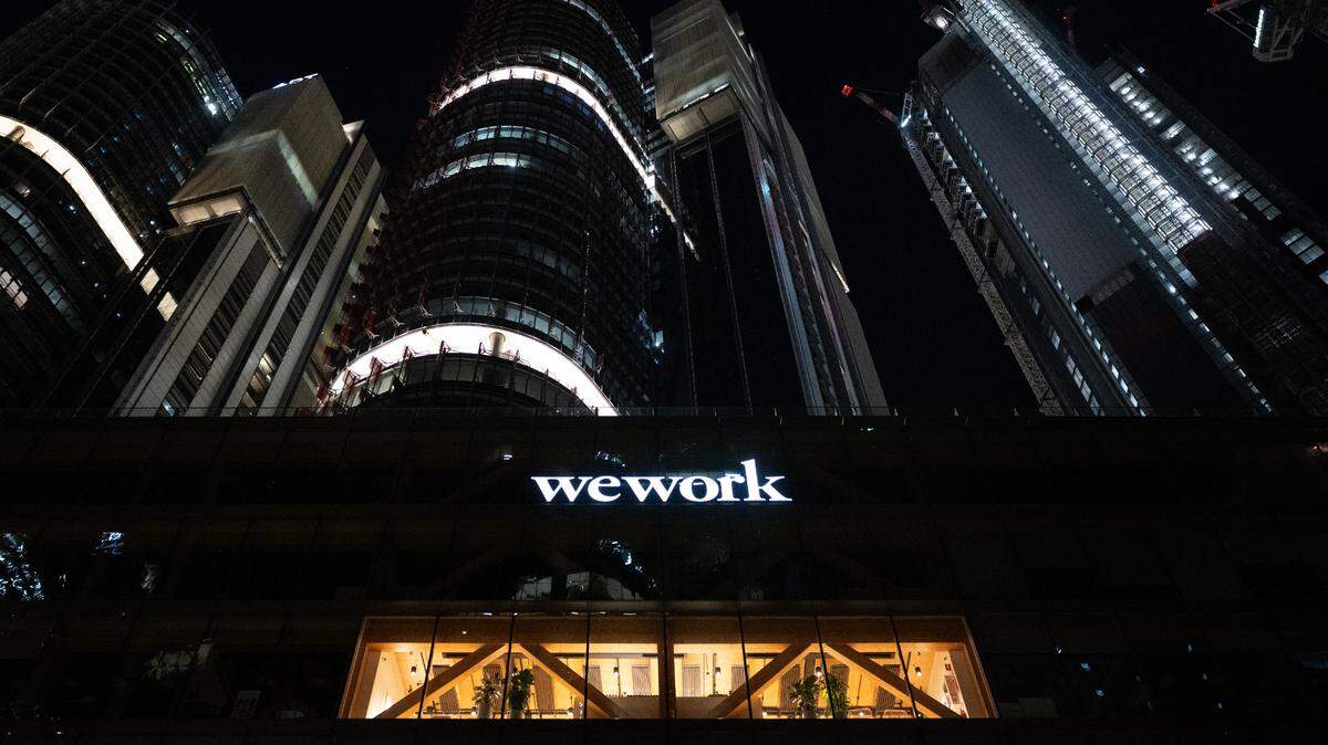 WeWork filed for bankruptcy in early November. It became a giant in providing shared workspaces across the globe. Above: The WeWork logo lit up an office building in Sydney, Australia. Photo: Sebastian Christoph Gollnow/dpa/Sipa USA