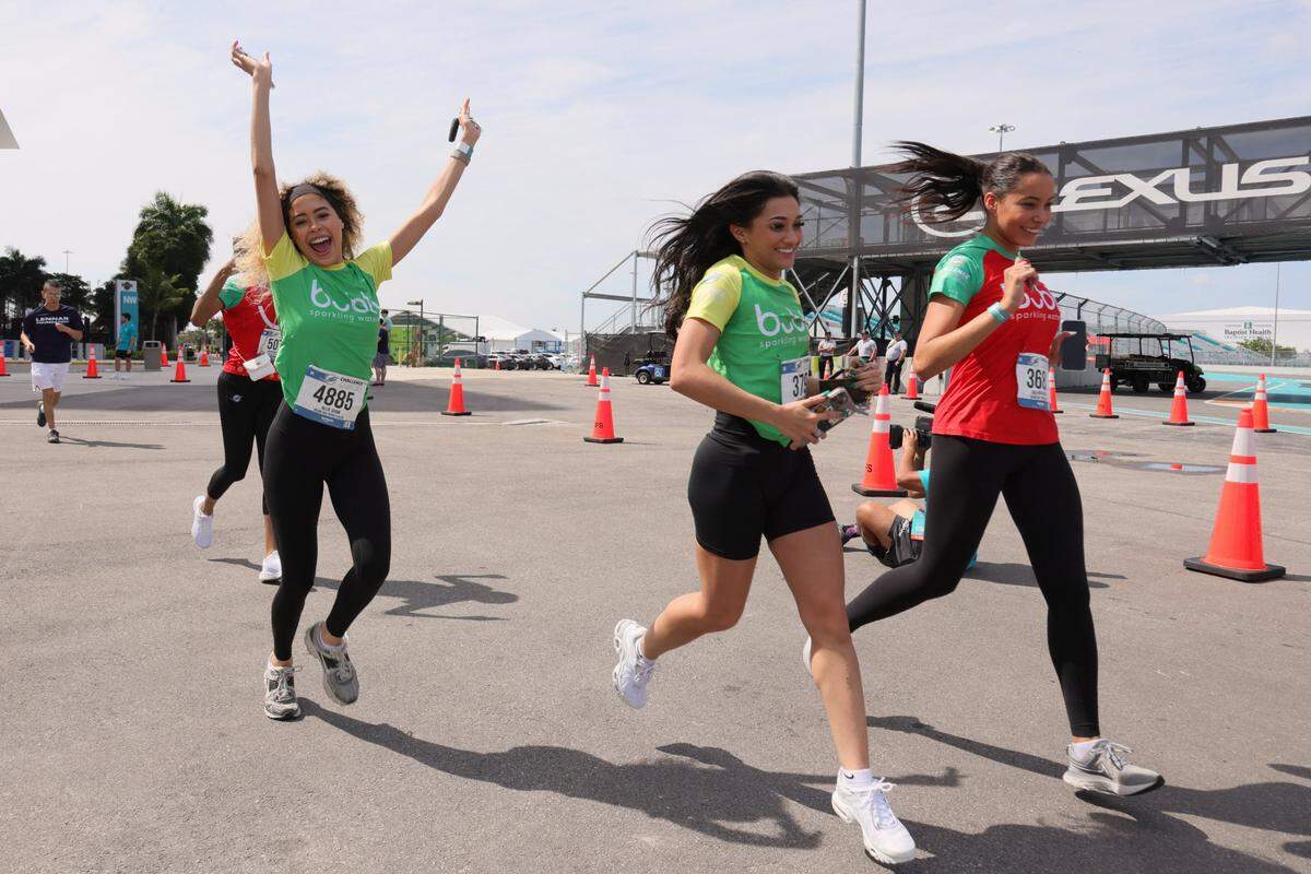 A group of runners react close to the finish line during the Dolphins Challenge Cancer XIV event at Hard Rock Stadium in Miami Gardens in February. The money collected goes toward life-saving cancer research at Sylvester Comprehensive Cancer Center.