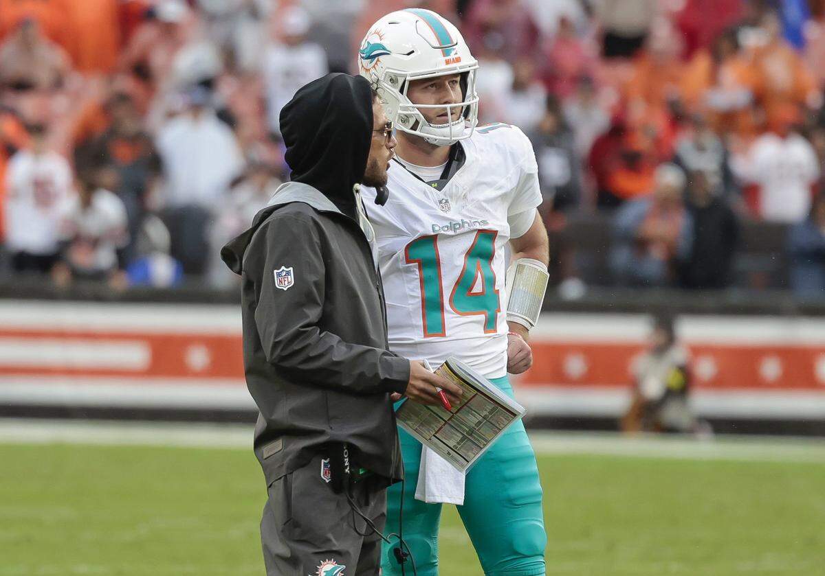 Miami Dolphins head coach Mike McDaniel speaks with quarterback Quinn Ewers (14) during the second half of an NFL football game against the Cleveland Browns at Huntington Bank Field in Cleveland, Ohio, on Sunday, October 19, 2025.