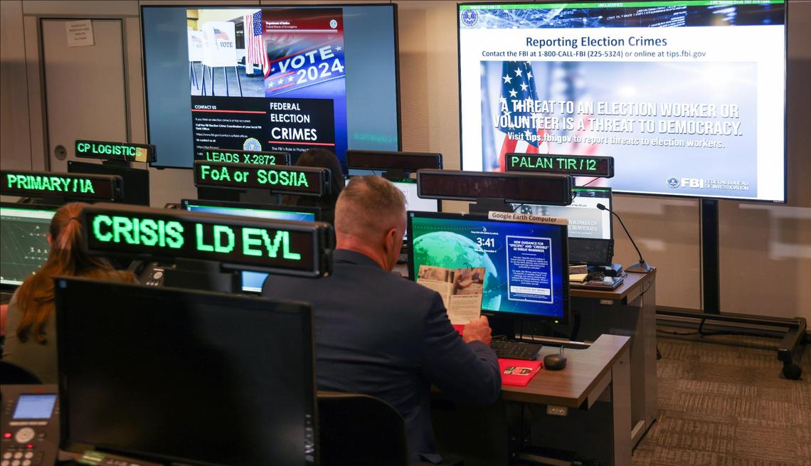 Members of the Election Threats Task Force, a partnership of DOJ and the FBI, operate in the Election Crime Command Post at the FBI Miami Field Office in Miramar, Florida, on Monday, November 4, 2024.