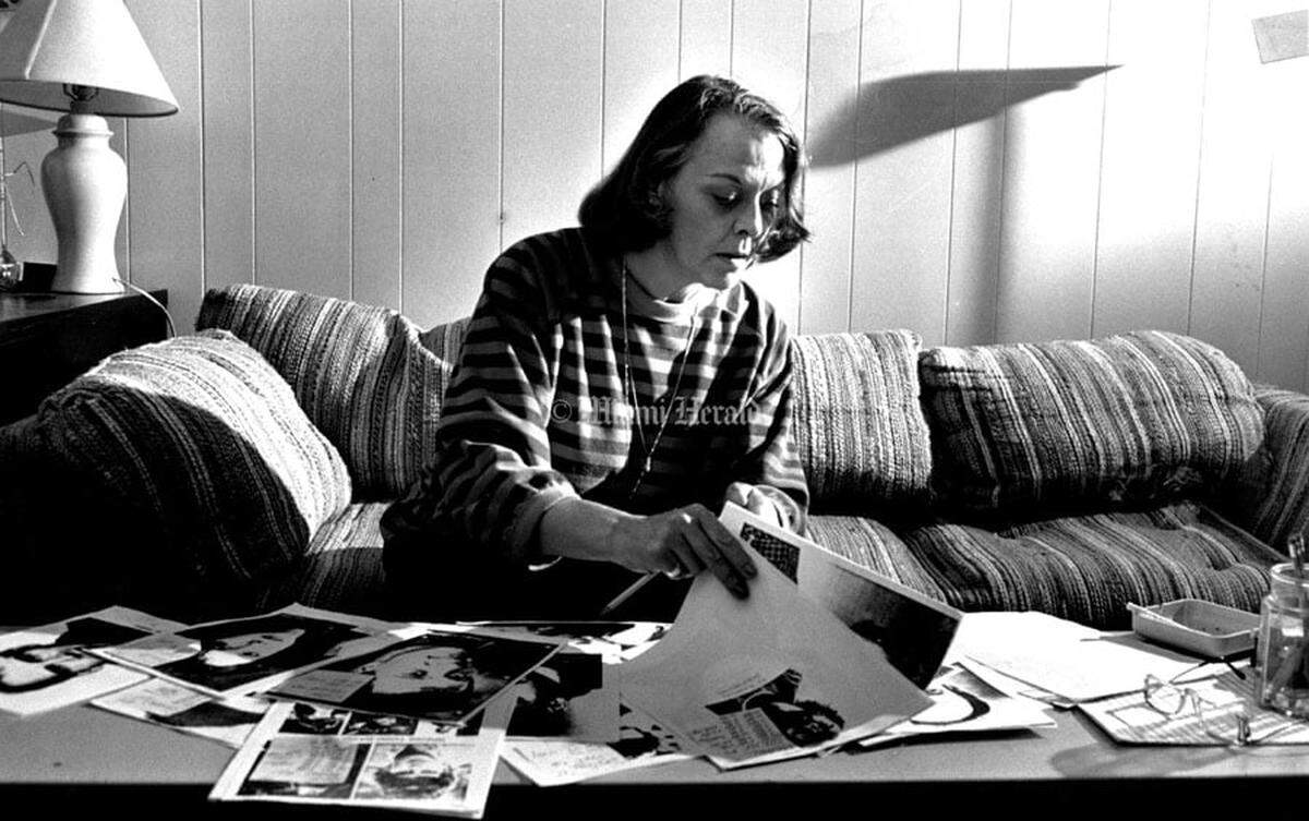 A Miami Herald archive photo of casting director Dee Miller looking over actors’ head shots as she helped cast the first three seasons of “Miami Vice” from 1984 to 1987 from her company’s office in North Miami, The Casting Directors.
