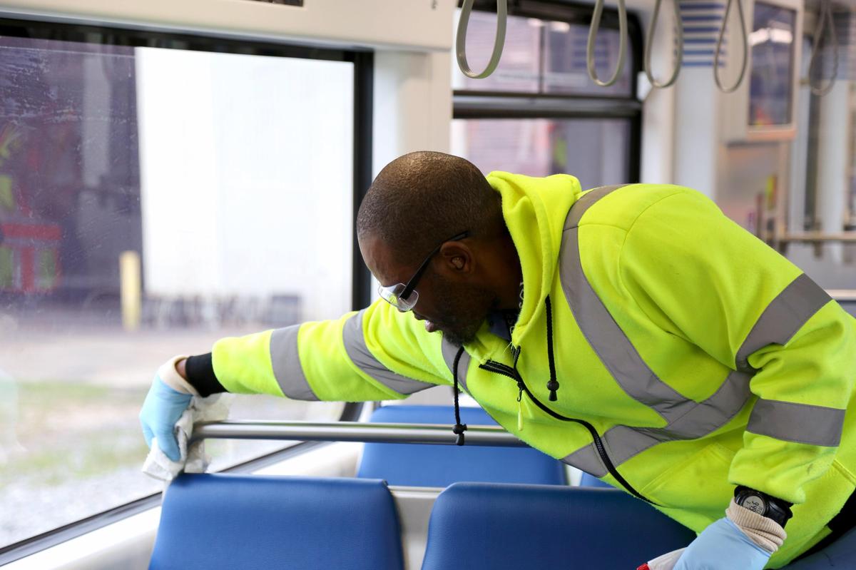 Andre Henry cleans a rail car from Miami-Dade County’s Metromover fleet. The county and other transit services are sanitizing vehicles more frequently and more thoroughly because of the novel coronavirus.