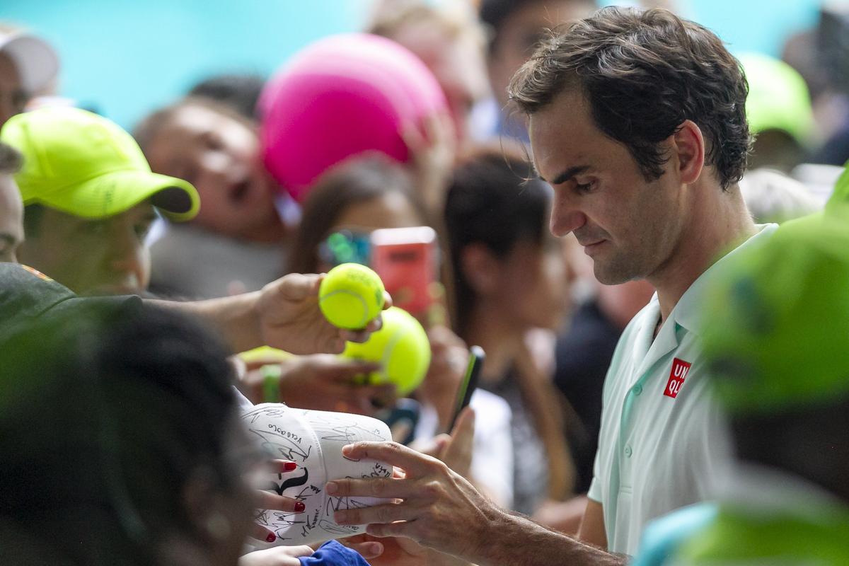 Roger Federer, of Switzerland, signs autographs for fans after defeating Daniil Medvedev, of Russia, during their match at the Miami Open tennis tournament on Wednesday, March 27, 2019, at Hard Rock Stadium in Miami Gardens.