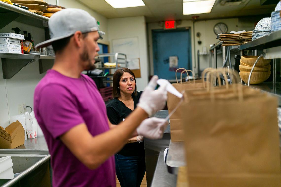 Ana Lugo, 43, prepare orders as a food runner at the Vietnamese-Cajun restaurant Phuc Yea, where owners have decided to deliver food themselves because of delivery apps’ high fees, which can eat 30% from each order.