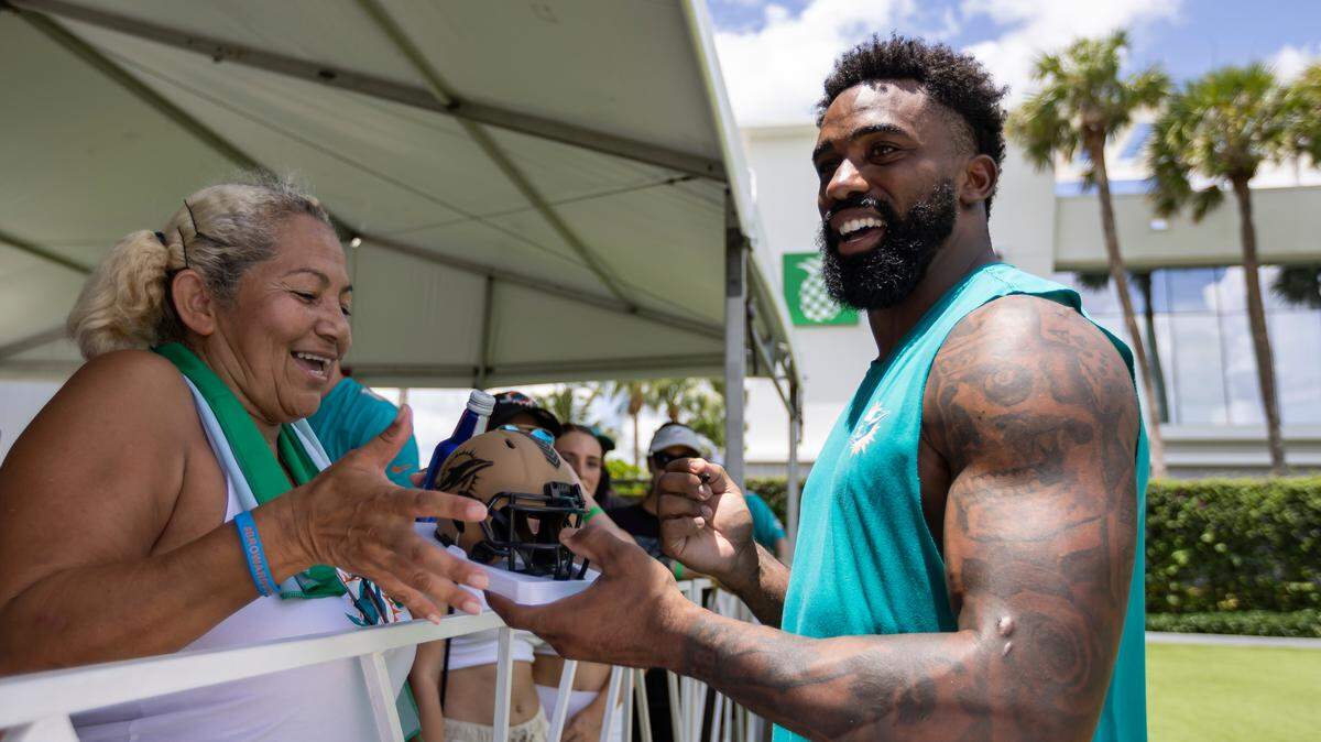 Miami Dolphins running back Raheem Mostert (31) signs autographs after attending a team practice at the Baptist Health Training Complex on Friday, Aug. 2, 2024, in Miami Gardens, Fla.