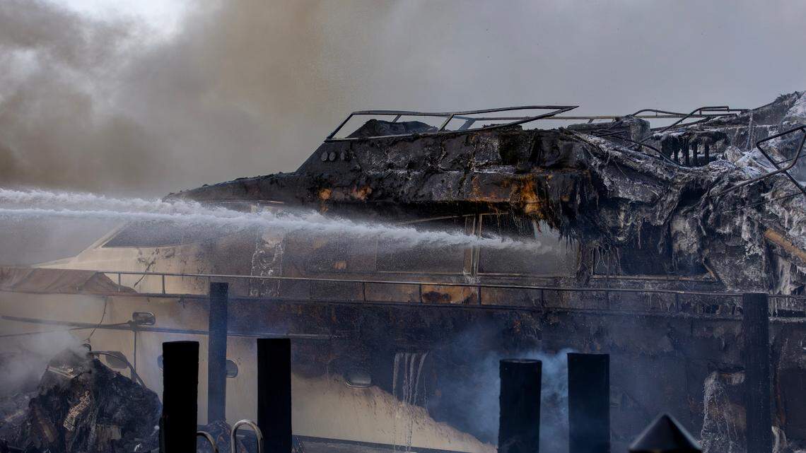 A charred boat at a dock in Sunny Isles Beach. Miami-Dade Fire Rescue and Miami Fire Rescue crews responded to multiple boat fires early Friday, June 6, behind a high-rise condominium at 400 Sunny Isles Blvd. Six boats were burned in the fires, including a 90-foot vessel, authorities said.