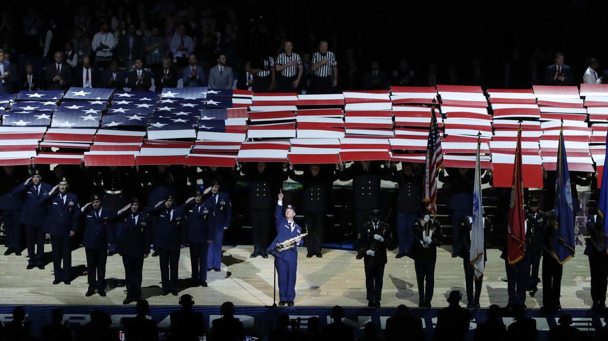 A service member performs the National Anthem before the championship game between Virginia and Texas Tech in the Final Four NCAA college basketball tournament, Monday, April 8, 2019, in Minneapolis.