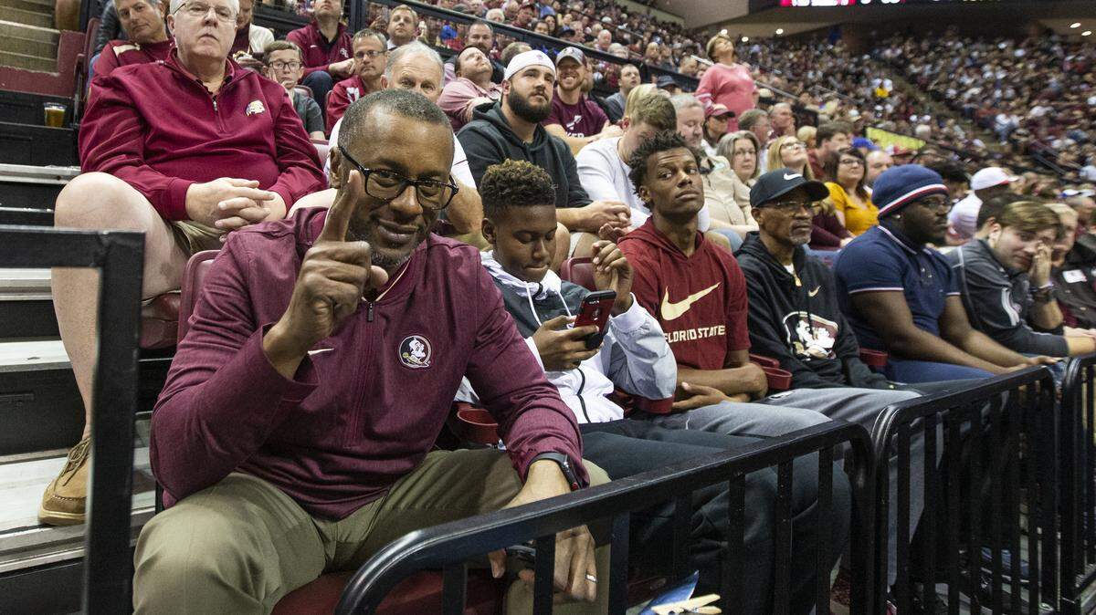Florida State head football coach Willie Taggart watches the basketball game in the second half of an NCAA college basketball game against Duke with son’s Jackson and Willie, Jr. in Tallahassee, Fla., Saturday, Jan. 12, 2019.