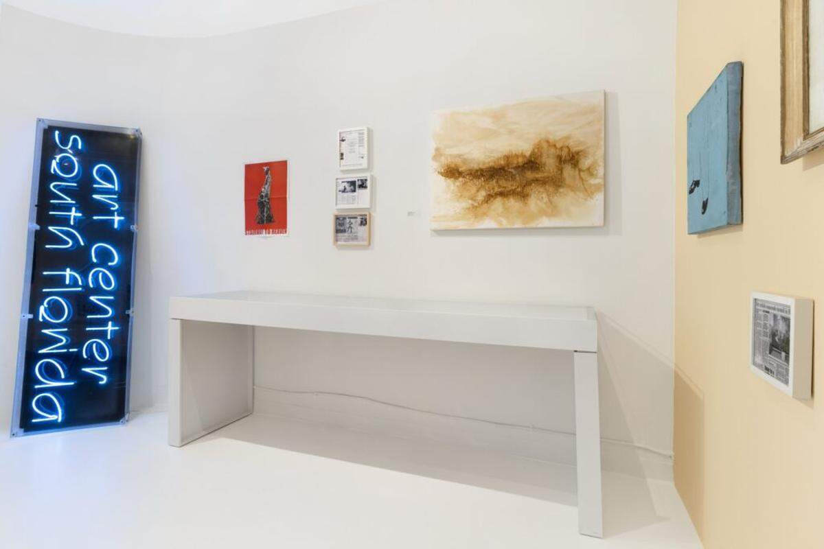 In the corner of one room at Oolite Arts sits a neon sign for ArtsCenter from the early 2000s. Photo artworks by Cordova, Ximenia Carrion and Manuel Acevedo hang alongside framed press clippings and posters.