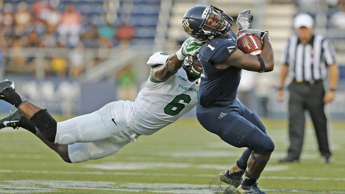 FIU running back Alex Gardner gains yardage against Marshall at Ocean Bank Stadium in Miami on Saturday, Oct. 18, 2014.