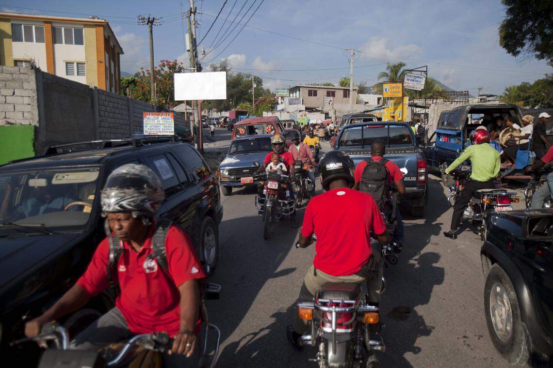 Motorcycle taxis ride in the traffic-clogged streets of Port-au-Prince, Haiti, in 2015. The Chinese-made vehicles began to flourish after Haiti's devastating earthquake of 2010, when foreign aid workers brought them in as part of their disaster-relief efforts.