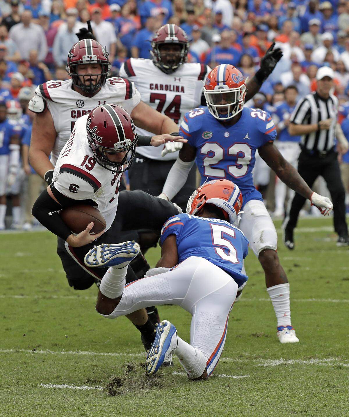 South Carolina quarterback Jake Bentley (19) is stopped by Florida defensive back CJ Henderson (5) during the first half of an NCAA college football game, Saturday, Nov. 10, 2018, in Gainesville, Fla.