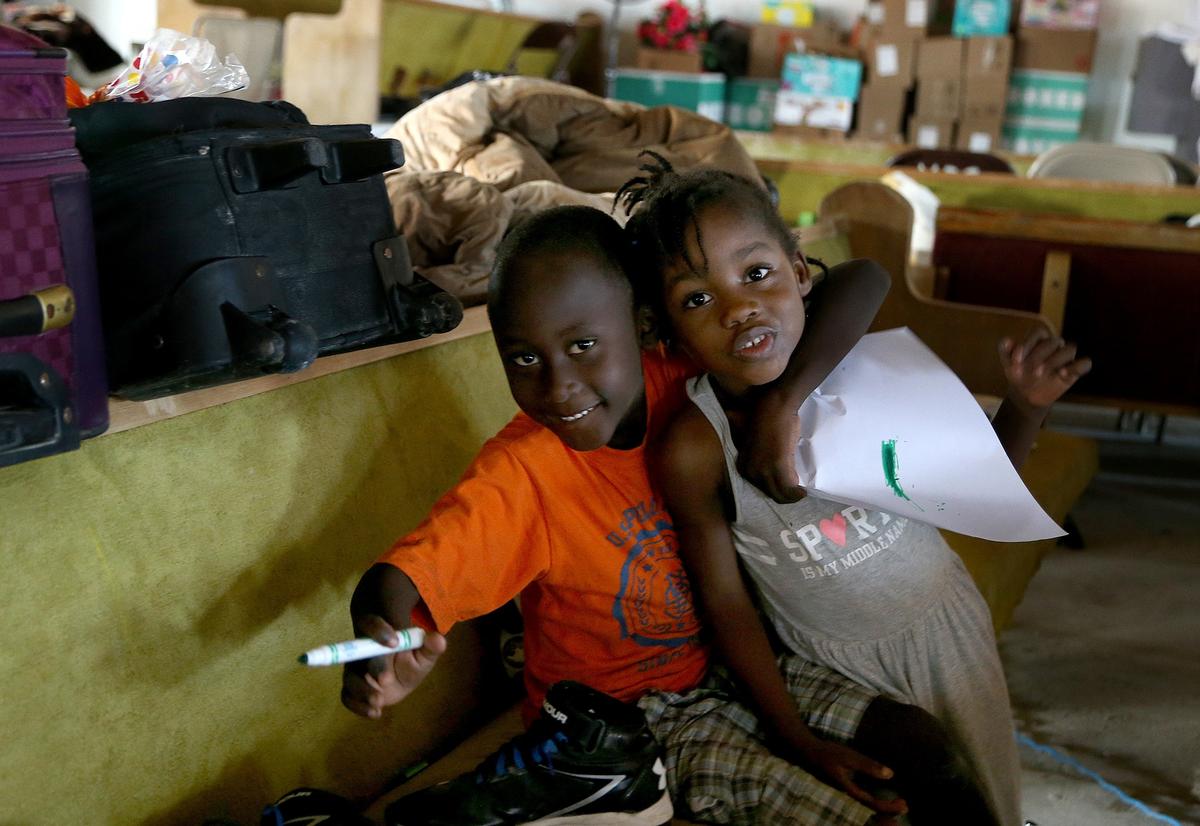 Haitian children play inside the New Haitian Mission Church on Sept. 12, 2019. The church is being used as a shelter close to Sand Banks neighborhood where mostly Haitians live on Treasure Cay in Abaco, The Bahamas, on Sept. 12, 2019. Abaco was ravaged by Hurricane Dorian.