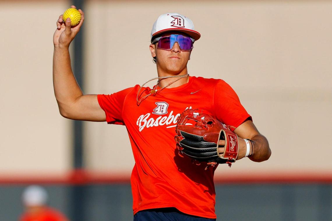 Doral Academy shortstop Adrian Santana (8), a University of Miami commit and MLB draft prospect, gets ready to throw a ball during a recent baseball practice at Doral Academy High School in Doral, Florida.
