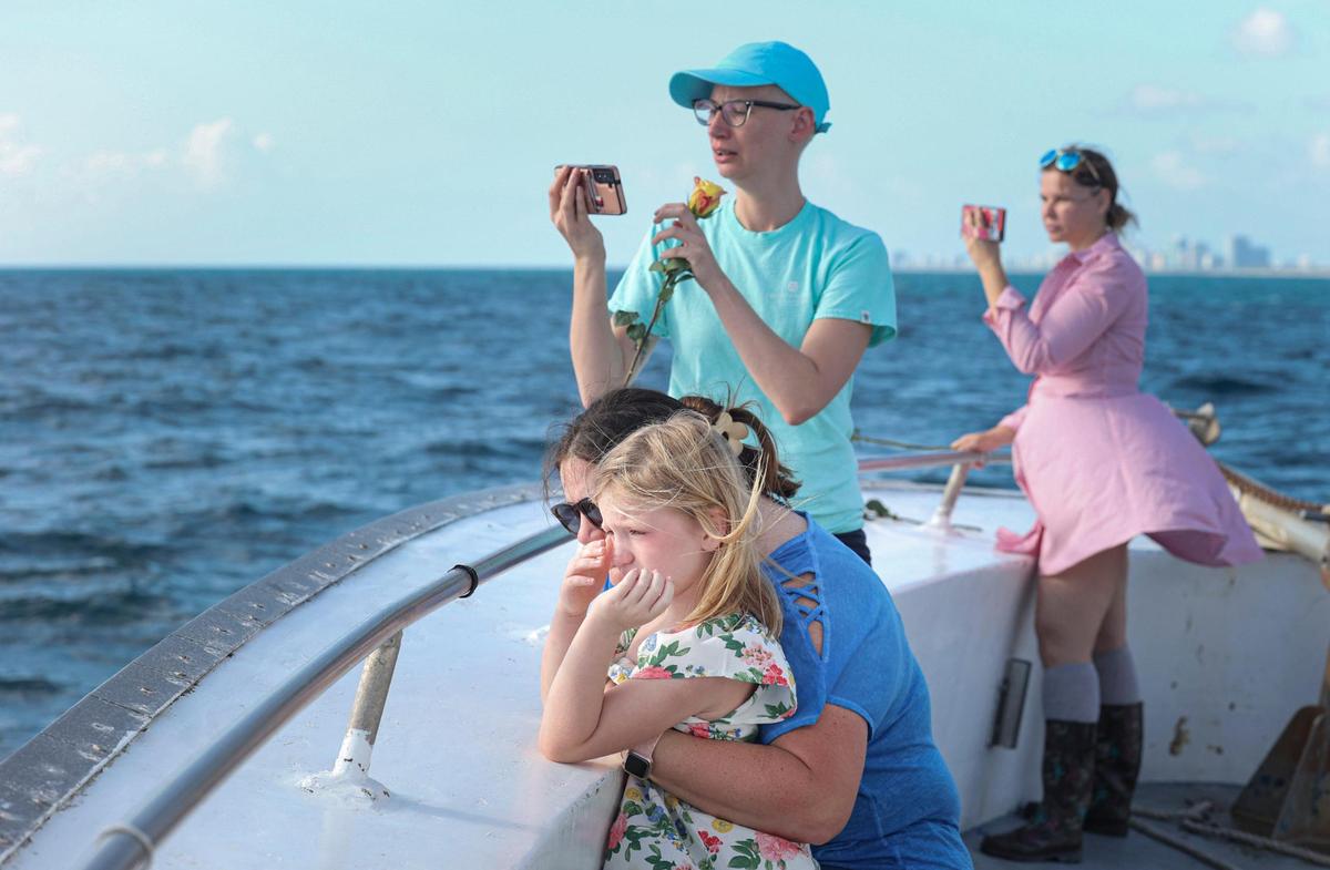Family of Dave McCammon, whose ashes turned into an artificial reef, attend a ceremony lowering the artificial reef urn into the water on Monday, March 27, 2023, at the reef in Golden Beach. Eternal Reefs is a company that works with families to turn the ashes of their loved ones into a concrete artificial reef so that they can become part of the reef and flourish with wildlife in the years to come.