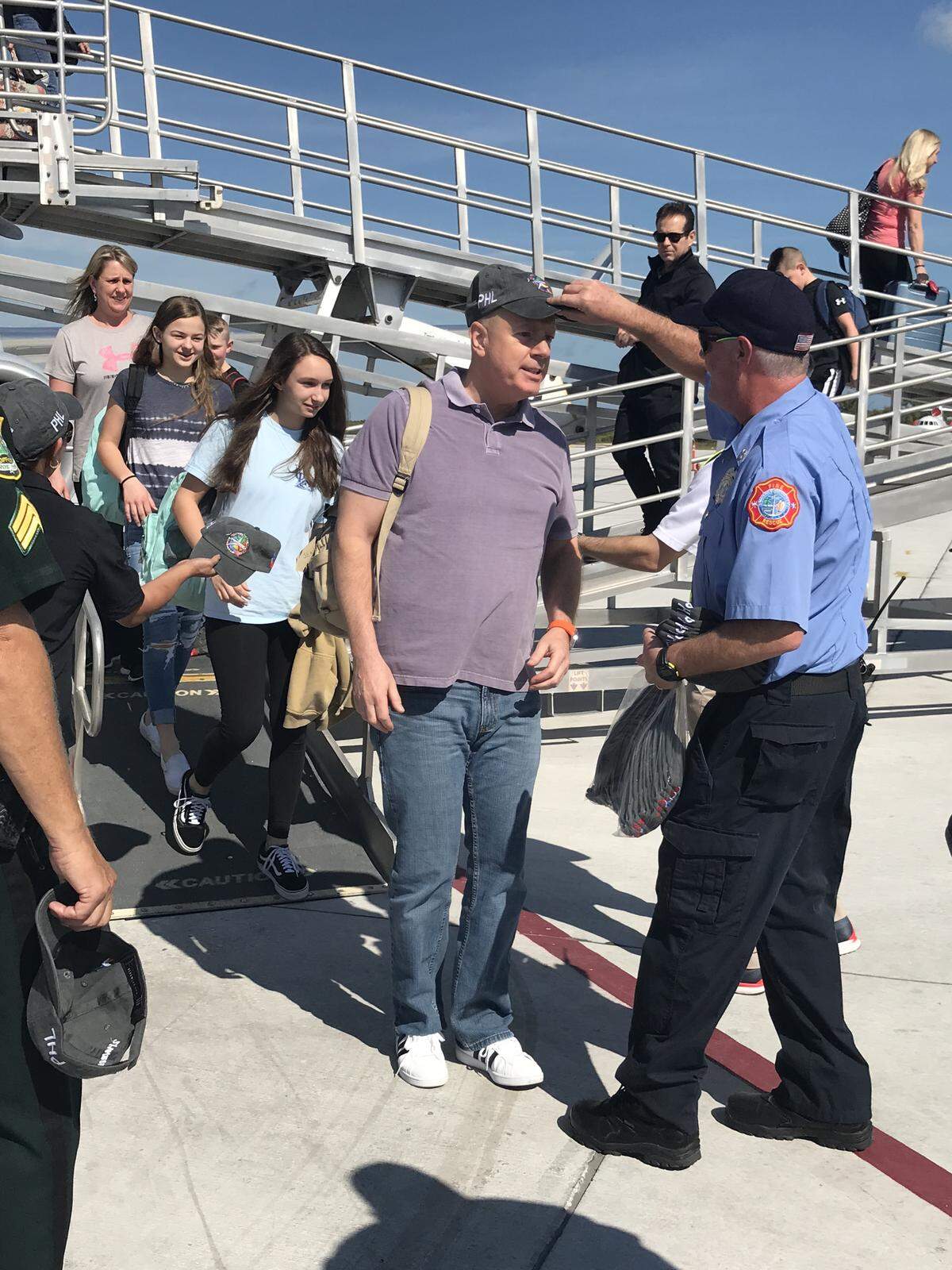 Passengers from Philadelphia International Airport’s Flight 1456 on Saturday are welcomed to Key West International Airport with commemorative hats.