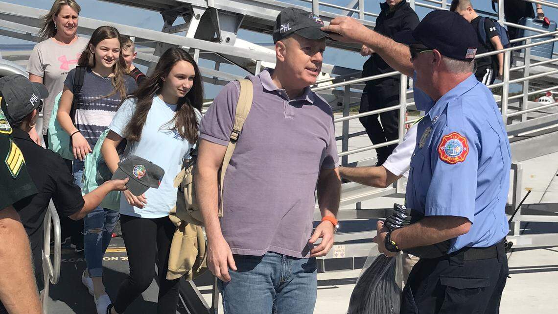 Passengers from Philadelphia International Airport’s Flight 1456 on Saturday are welcomed to Key West International Airport with commemorative hats.