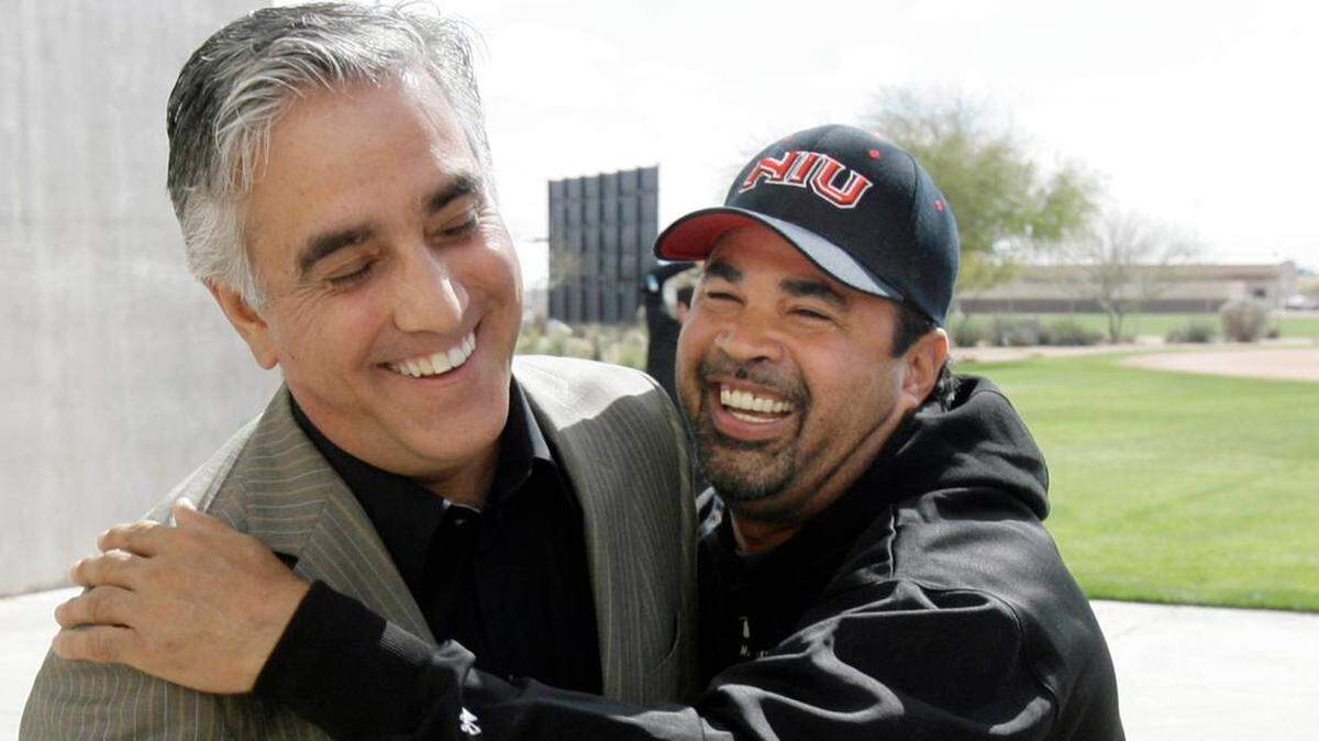 Longtime ESPN baseball journalist Pedro Gomez (left), a Miami native, jokes with Chicago White Sox manager Ozzie Guillen at Spring Training in 2008. Gomez died at age 58 on Feb. 7, 2021.