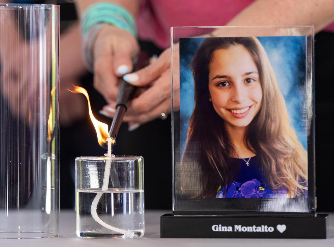 A candle is lit in honor of Gina Montalto during the ‘Forever in Our Hearts’ commemoration event outside of the Eagles’ Haven Wellness Center on Friday, Feb. 14, 2025, in Coral Springs, Fla. The event aims to honor the 17 lives lost during the Marjory Stoneman Douglas High School shooting in 2018 and their families.