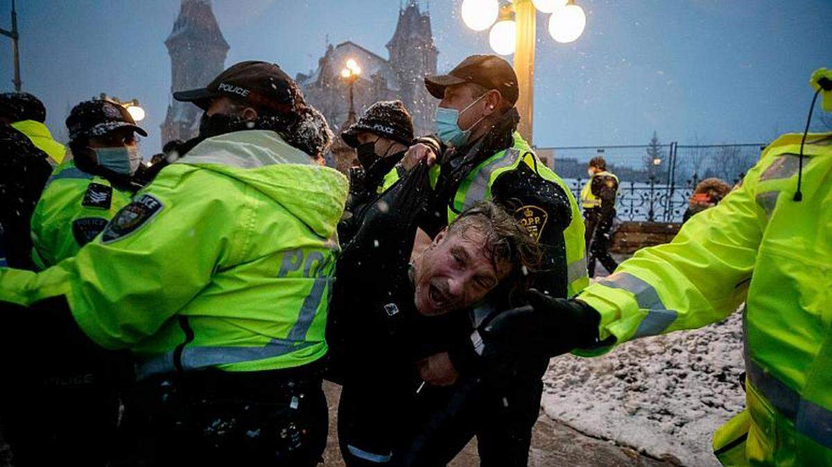 Police arrest a man during protests against COVID-19 measures that clogged downtown Ottawa, Ontario, in February.