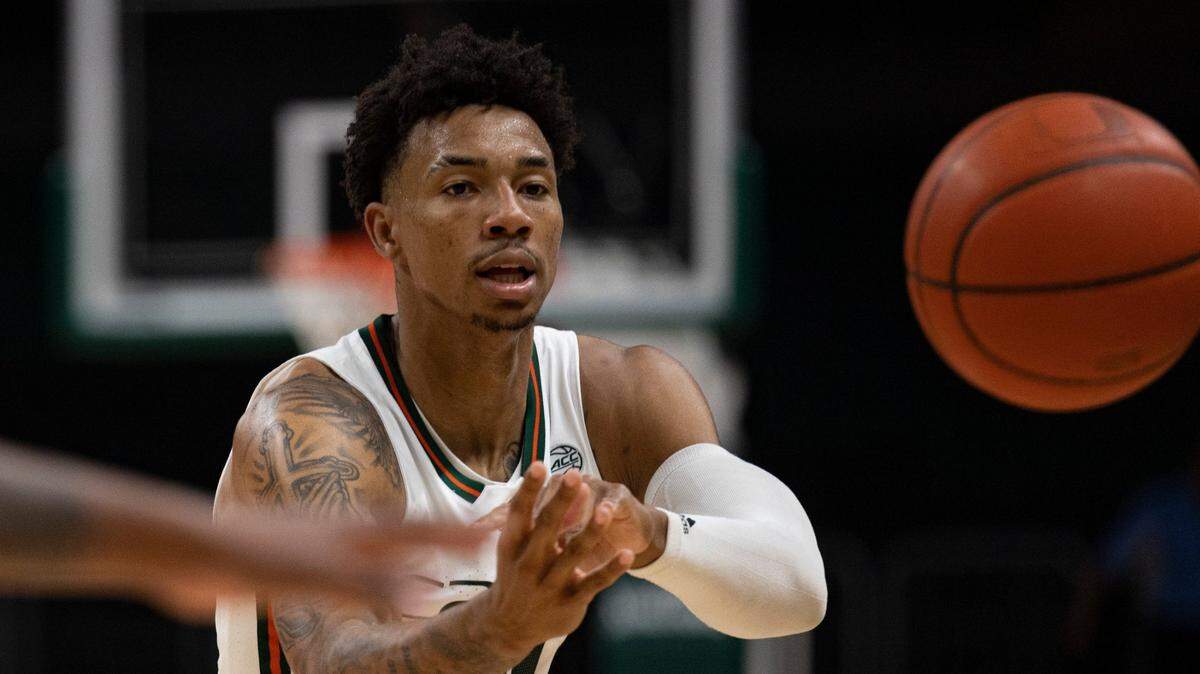 Miami guard Jordan Miller (11) passes the ball to a teammate during the second half of a game against the St. Francis Brooklyn Terriers on Wednesday, Nov. 23, 2022, at the Watsco Center in Coral Gables. Miami won 79-56.