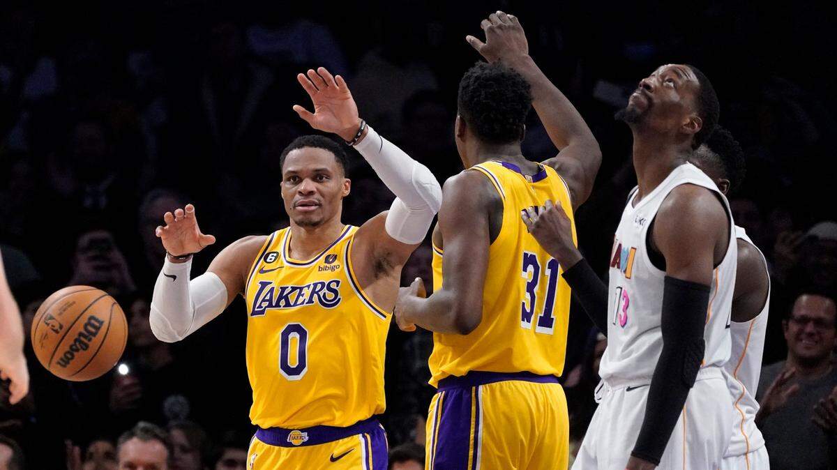 Los Angeles Lakers guard Russell Westbrook, left, celebrates with center Thomas Bryant, center, after scoring as Miami Heat center Bam Adebayo stands by during the second half of an NBA basketball game Wednesday, Jan. 4, 2023, in Los Angeles.