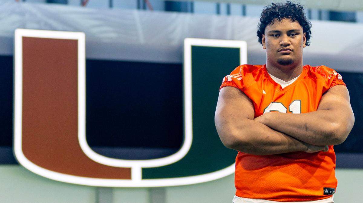 University of Miami offensive lineman Francis Mauigoa (61) strikes a pose during media availability at UM’s Carol Soffer Indoor Practice Facility in Coral Gables, Florida, on Tuesday, August 22, 2023.