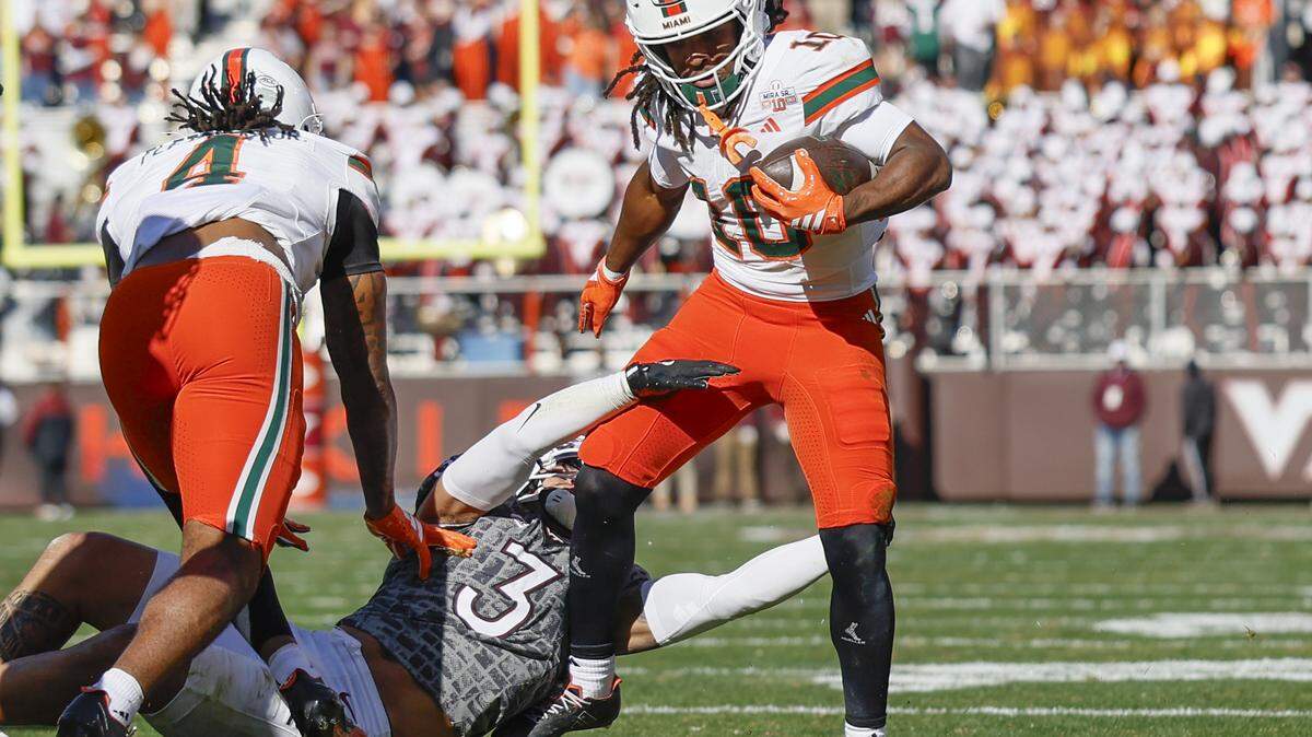 Miami Hurricanes wide receiver Malachi Toney (10) breaks a tackle after a pass reception as Virginia Tech Hokies linebacker Kaleb Spencer (3) defends in the first half at Lane Stadium in Blacksburg, Virginia, on Saturday, November 22, 2025.