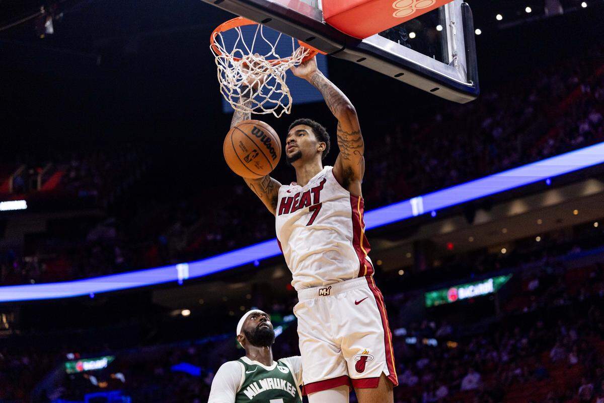 Miami Heat center Kel'el Ware (7) dunks the ball during the first half of an preseason NBA game against the Milwaukee Bucks at Kaseya Center on October 6, 2025, in Miami.