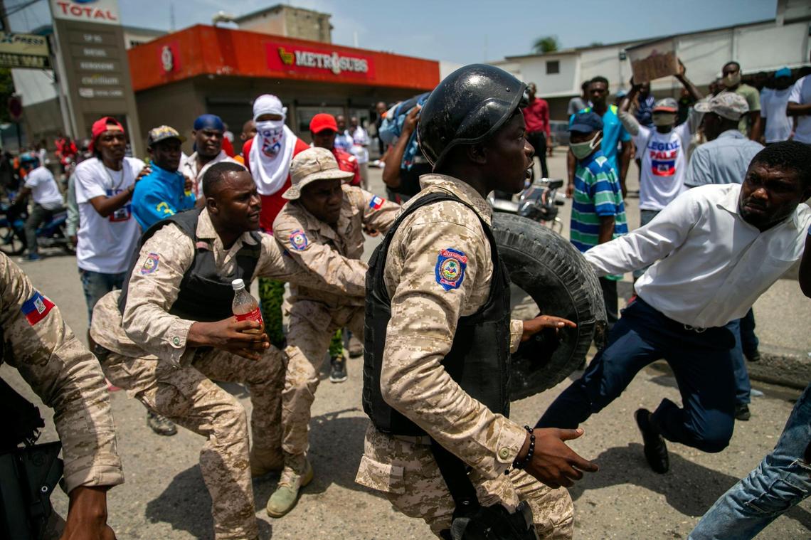 Police and demonstrators scuffle during a protest against gay rights in Port-au-Prince, Haiti, Sunday, July 26, 2020. The group marched demanding that President Jovenel Moise rescind his most recent decree that rewrites the 185-year-old penal code.