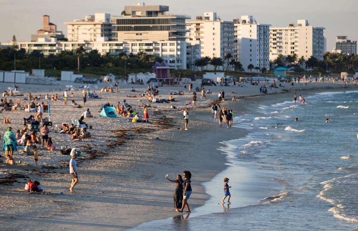 People visit South Pointe Beach on Monday, Feb. 27, 2023, in Miami Beach, Fla.