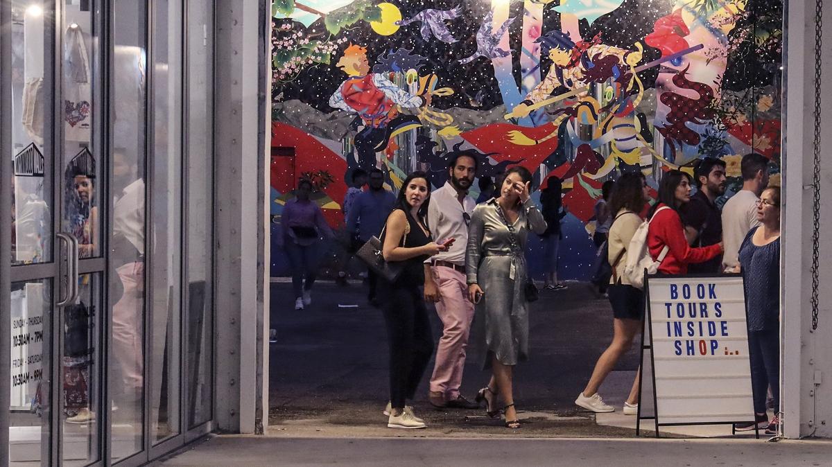 Wynwood Walls visitors walk through the outdoor gallery on Sunday, November 25, 2019.