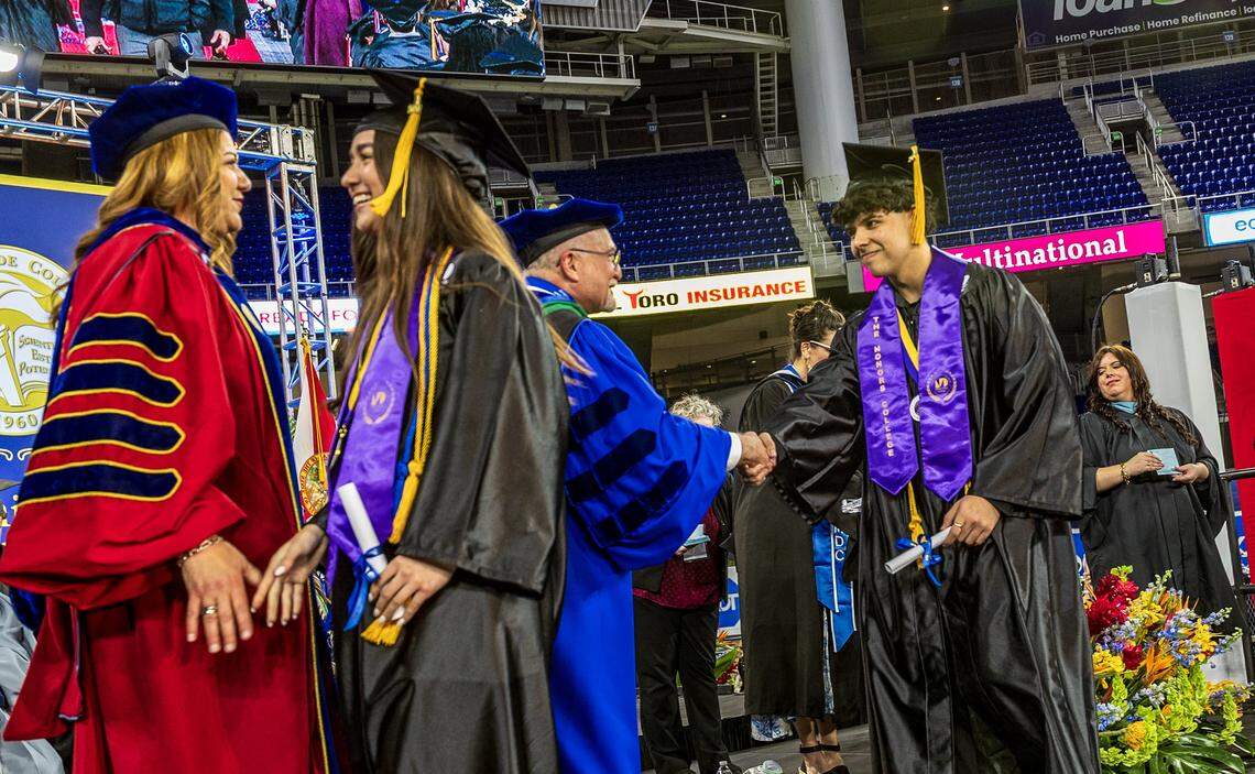 MDC President Madeline Pumariega looks on as Dr. Bryan Stewart, President of MDC's Kendall Campus greets David Alejandro Ramírez Núñez (far right), after he earned a degree in Mechanical Engineering and he will be heading to MIT during the Miami Dade College's Kendall and Padrón Campuses 2026 Commencement ceremonies at the LoanDepot Park, in Miami on Saturday, April 25, 2026.