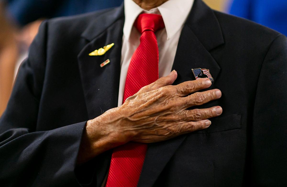 El veterano del Ejército de Estados Unidos Richard Goon, de 98 años, en el centro, es felicitado mientras sostiene la Medalla de Oro del Congreso durante una ceremonia virtual en la Grand Villa Senior Living Community el martes 5 de julio de 2022 en Deerfield Beach, Florida. Durante su servicio, Goon se capacitó como criptógrafo y finalmente fue destinado a la frontera entre China e Indochina, donde ayudó al ejército chino a luchar contra las fuerzas japonesas.