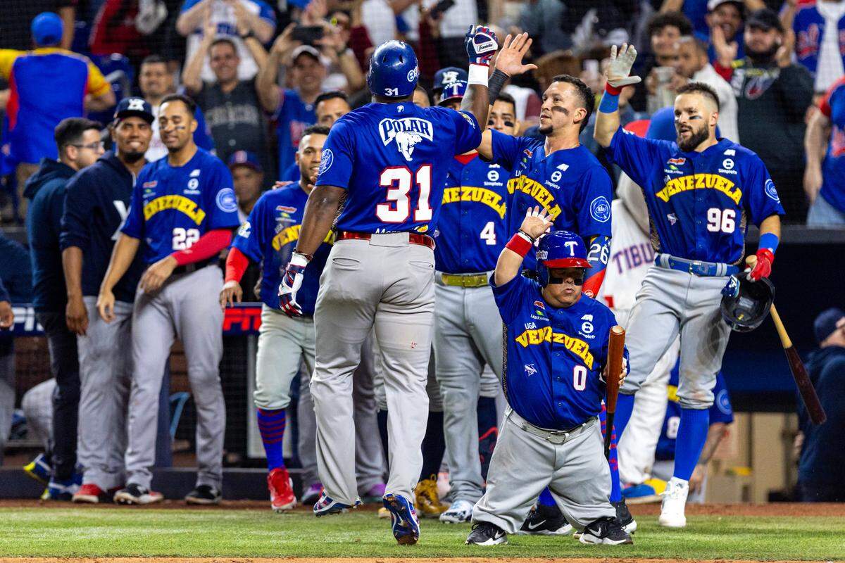 Venezuela base runner Yasiel Puig (31) reacts with teammates after homering to left field during the eighth inning of a Caribbean Series baseball game at loanDepot park in Miami, Florida, on Thursday,February 1, 2024.