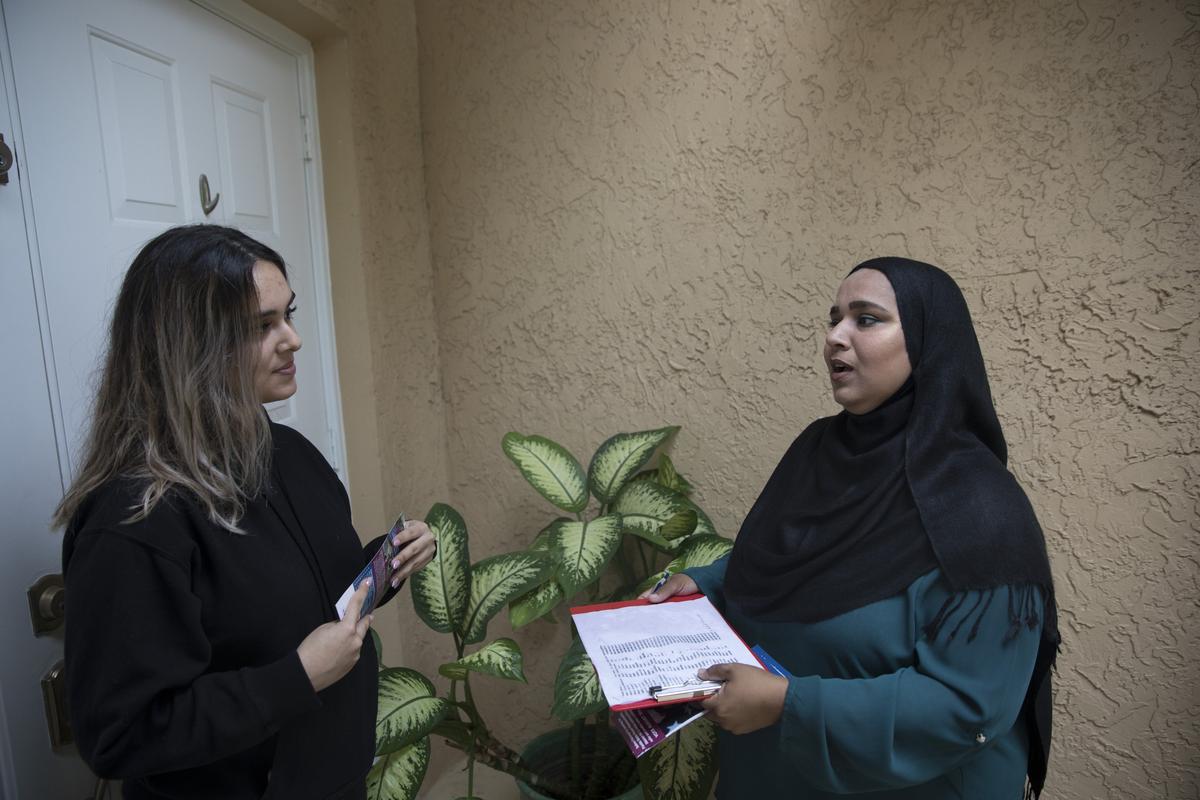 Florida House District 96 candidate Saima Farooqui speaks to Maria Cardenas, 20, of Coconut Creek on Sunday, June 10. Farooqui went door-to-door speaking to potential voters.