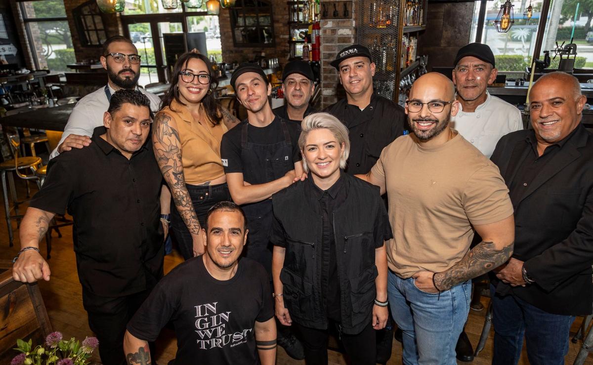 Chef Eileen Andrade, center, poses with some of her staff at Finka Table & Tap in Kendall.